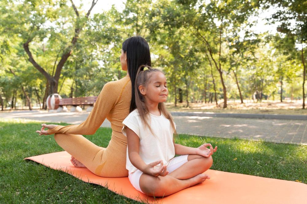 How to make Kids Healthy, Mindful, and Active in Philadelphia 1 girl doing yoga with fitness instructor
