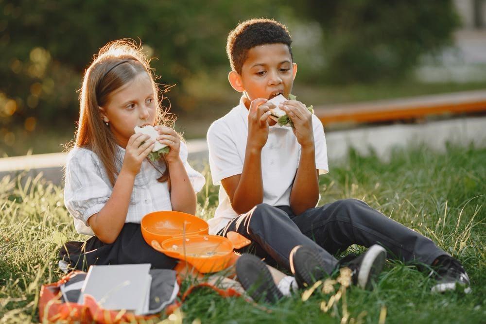 Kids eating lunch part of summer camp routine