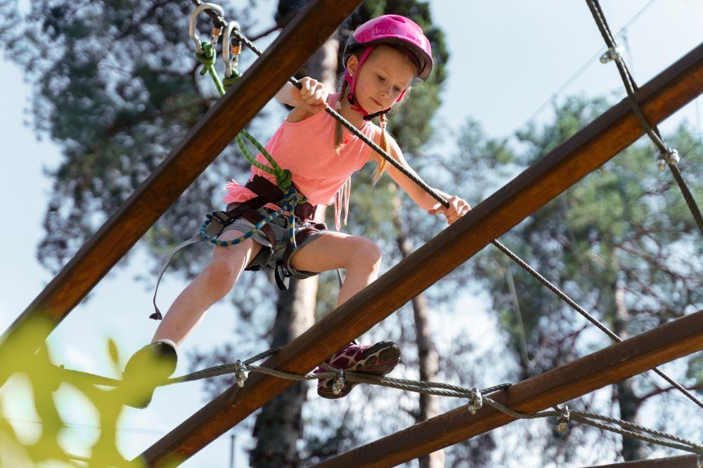 kid climbing wall for boosting confidence which is a advantage of summer camp