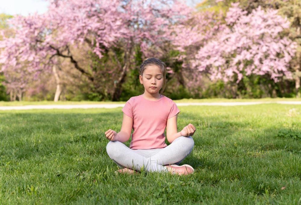 Girl kid doing mindfulness exercise in summer camp program
